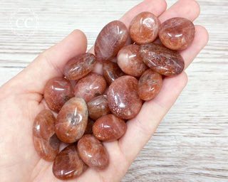 African Sunstone Tumbled Crystals in hand