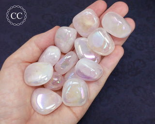 Aura Rose Quartz tumbled crystals in hand