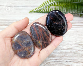 Black Moonstone Palm Stones in hand