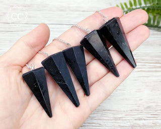 Black Tourmaline Pendulums in hand