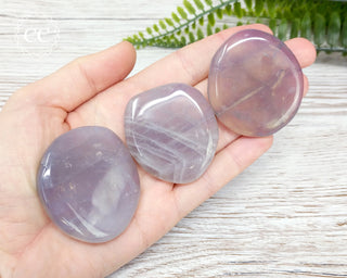 Blue Rose Quartz Palm Stones in hand