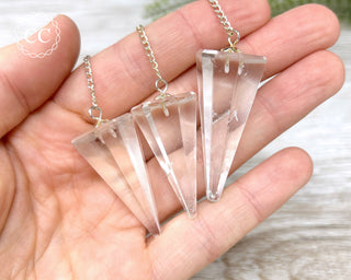 Clear Quartz Pendulums in hand