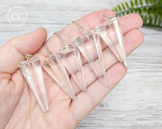 Clear Quartz Pendulums in hand