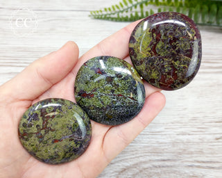 Dragons Blood Jasper Palm stones in hand