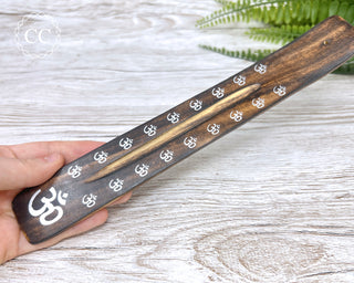 Long Wooden Incense Stick Holder in hand on light background