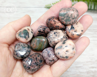 Isla Rosa Tumbled Crystals in hand