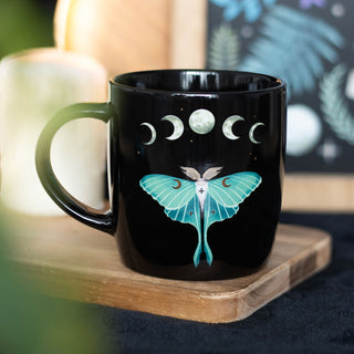 Luna Moth Ceramic Mug on table