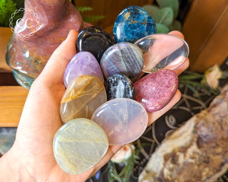 Flat crystal palm stones in hand
