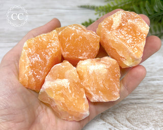 Orange Calcite Raw crystals in hand