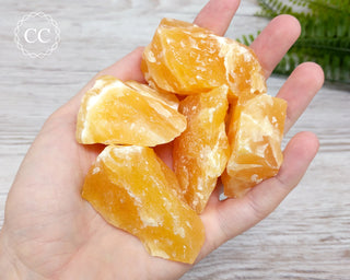 Orange Calcite Raw Crystals in hand