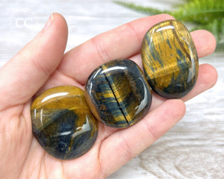 Blue Gold Tigers Eye Palm Stones in hand