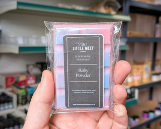 Baby Powder wax melt bar in hand