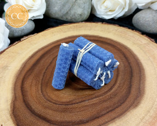 Mini Blue rolled Beeswax Spell Candles on wooden background 