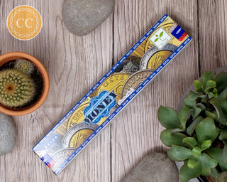 Satya Money Incense sticks on wooden background