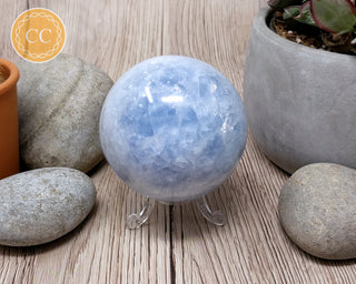 Blue calcite sphere in clear plastic sphere stand