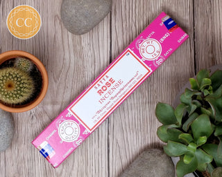 Satya Rose Incense sticks on wooden background