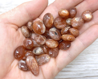 African Sunstone Tumbled Crystals in hand