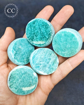 A hand holding 5 Amazonite Dragon Eggs from Madgascar