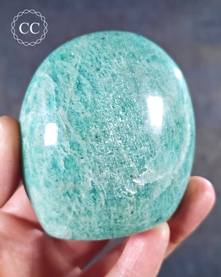 A hand holding an Amazonite freeform from Madagascar