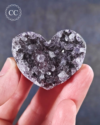 A hand holding an Amethyst Cluster Heart from Brazil

