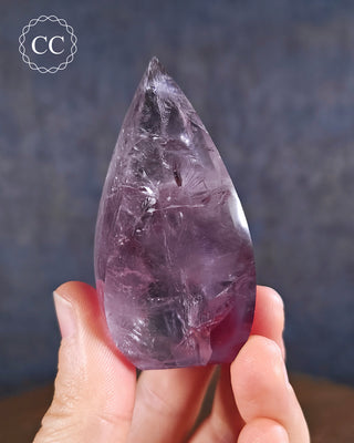 Amethyst Flame in hand on blue background