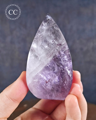 Amethyst Flame in hand on blue background