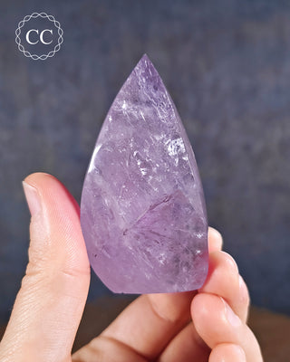 Amethyst Flame in hand on blue background