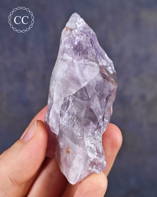 Amethyst with natural green Prasiolite from Thunder Bay in Ontario shown in the hand.