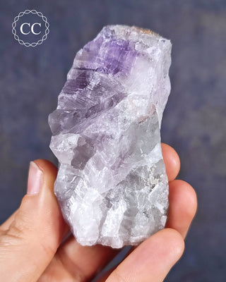 Amethyst with natural green Prasiolite from Thunder Bay in Ontario shown in the hand.