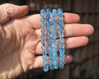 Aquamarine 6mm Beaded Bracelets in hand