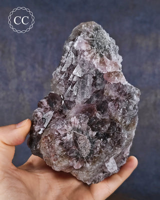 A hand holding an unusual Amethyst specimen from Brazil