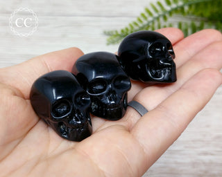 Black Obsidian Skull crystal carving in hand