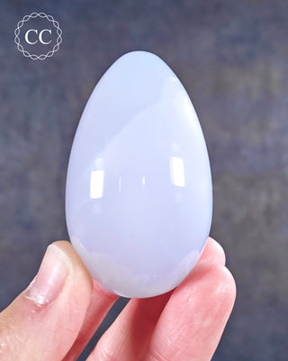 A hand holding a Blue Chalcedony Egg
