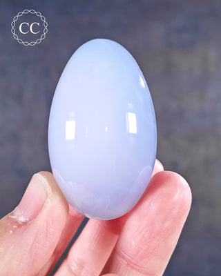 A hand holding a Blue Chalcedony Egg