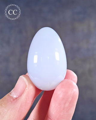 A hand holding a Blue Chalcedony Egg