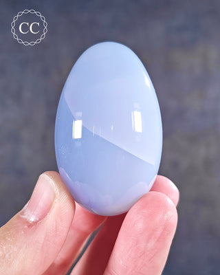 A hand holding a Blue Chalcedony Egg