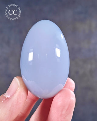 A hand holding a Blue Chalcedony Egg