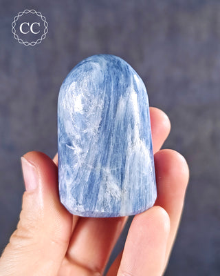 A hand holding a Blue Kyanite Freeform from India 
