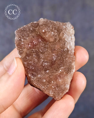A hand holding a specimen of Botryoidal Fluorite from the Tres Marias Mine in Mexico
