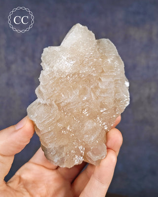 A hand holding a Calcite Specimen from Bulgaria 