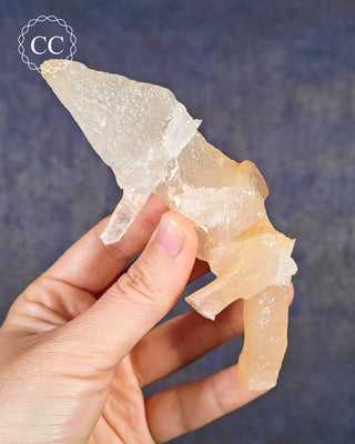 A hand holding a Calcite Stalactite from Spain 