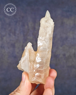 A hand holding a Calcite Stalactite from Spain 