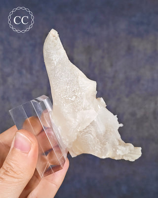 A hand holding a Calcite Stalactite from Spain 