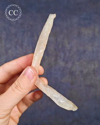 A hand holding a Calcite Stalactite from Spain 