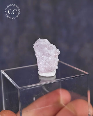 A rare Canga Rosa specimen, also known as Crystallised Rose Quartz specimen on a clear display box 