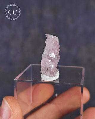 A rare Canga Rosa specimen, also known as Crystallised Rose Quartz specimen on a clear display box 