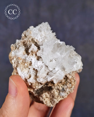 A hand holding a specimen of Celestite from the closed Muculufa Mine