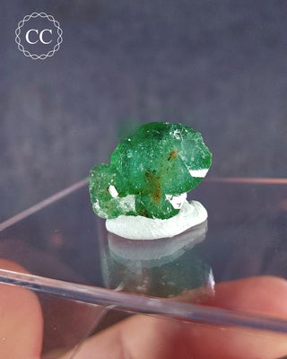  A rare Chrome Tourmaline mineral  from Tanzania on a clear display box 