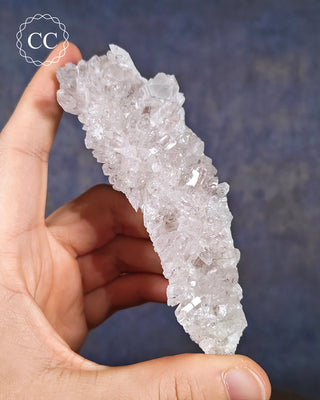 A hand holding a Clear Quartz Cluster from Brazil 