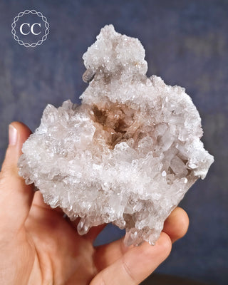 A hand holding a Clear Quartz Cluster from Brazil 